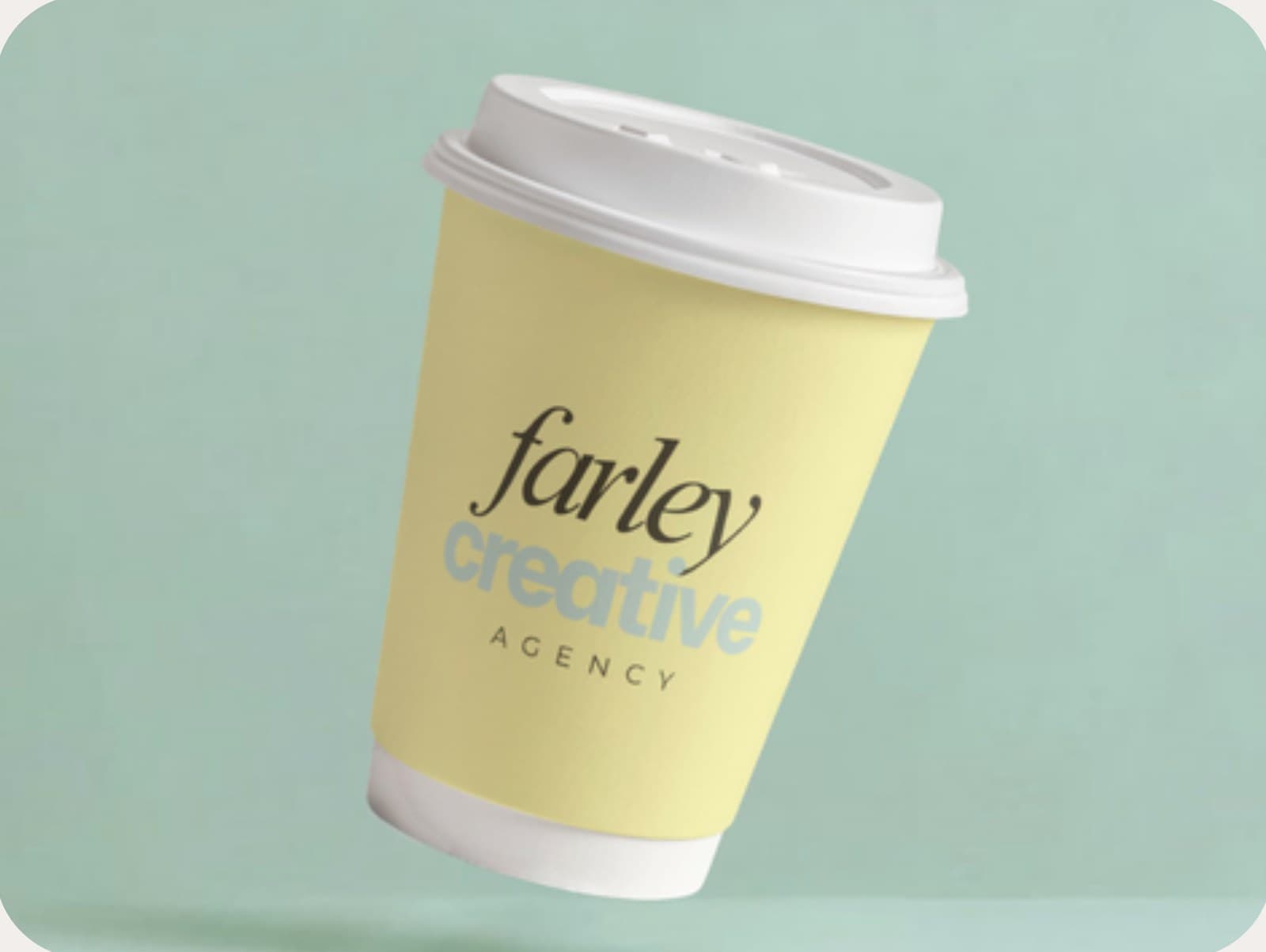 Farley Creative branded to-go coffee cup on a seafoam backdrop